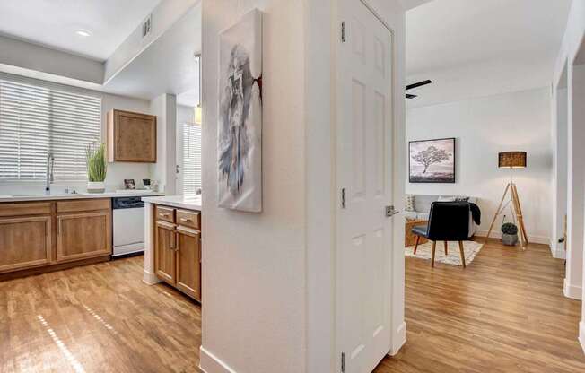 A kitchen with wooden floors and a white door.
