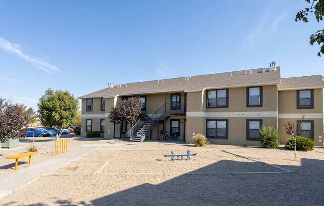 A large apartment complex with a playground in front.