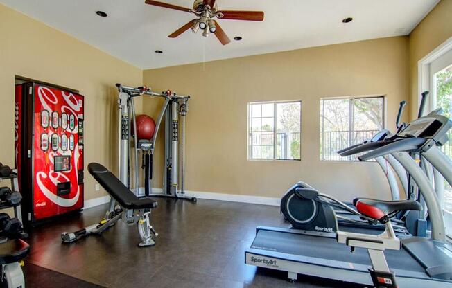 a home gym with a coke machine
