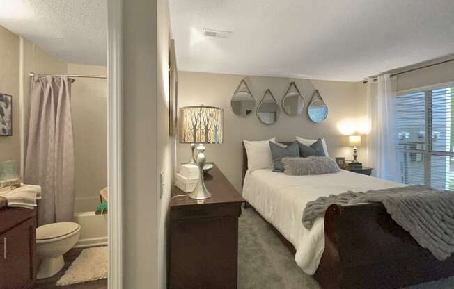 a bedroom with a bed and a bathroom with a toilet