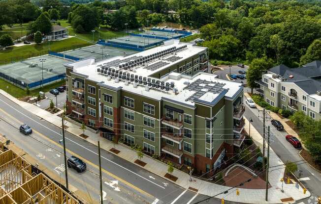 an aerial view of an apartment building with a parking lot