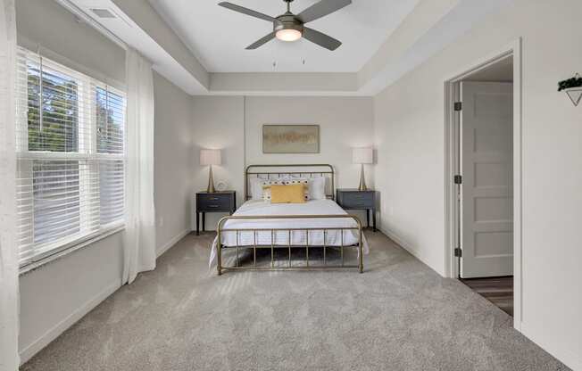 a bedroom with a bed and a ceiling fan