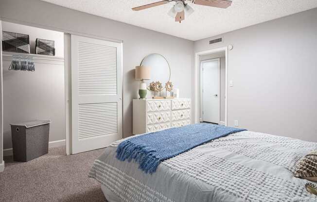 a bedroom with a bed and a ceiling fan  at The Park at Chesterfield Apartment Homes, Tampa