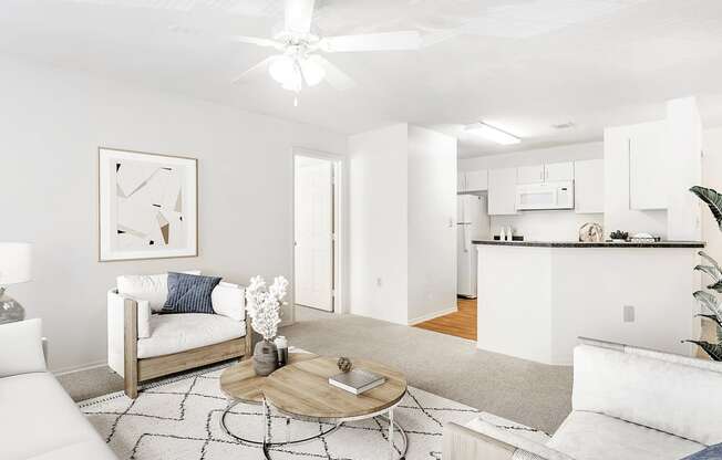 Virtually staged living room with carpet,a ccent rug, white couch with chairs, wall decor overlooking kitchen with breakfast bar