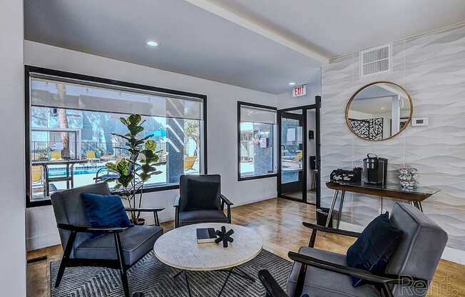 A living room with a black chair and a round table.