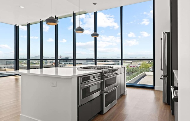 A modern kitchen with a large island and stainless steel appliances.