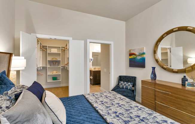 a bedroom with a bed and a mirror and a closet at Aster Apartments, Beachwood, OH
