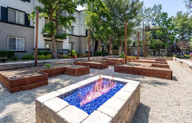 a fire pit in the middle of a courtyard with benches