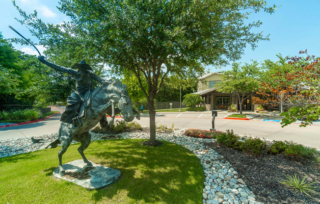 a statue of a man riding a horse in a park
