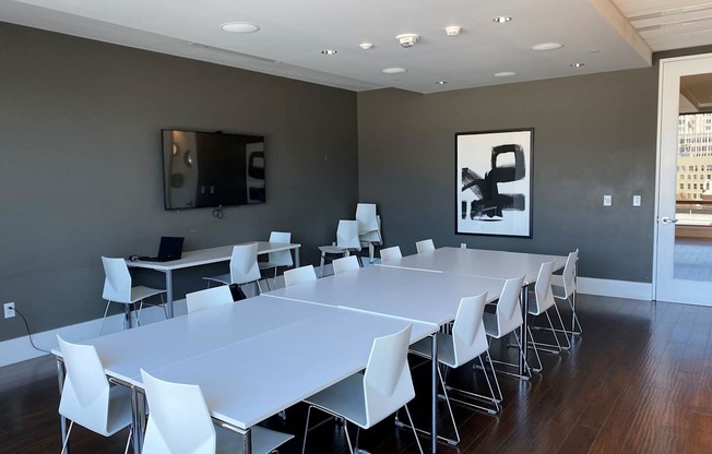 A conference room with a long table and chairs.