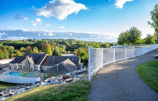 a view of a house and a chain link fence with a house in the background