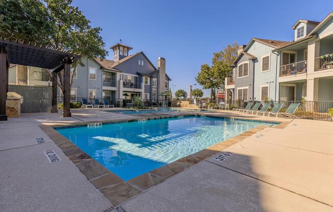 a house with a pool in front of a building