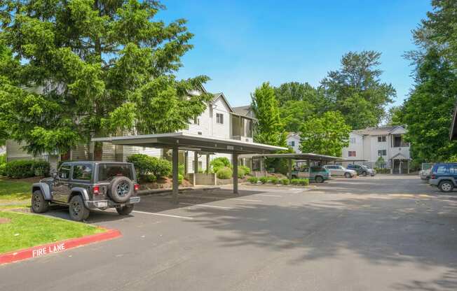 a parking lot with a jeep parked in front of a house