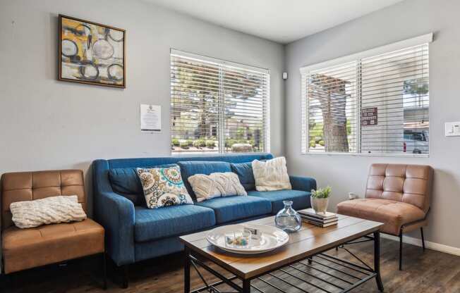 a living room with a blue couch and a coffee table