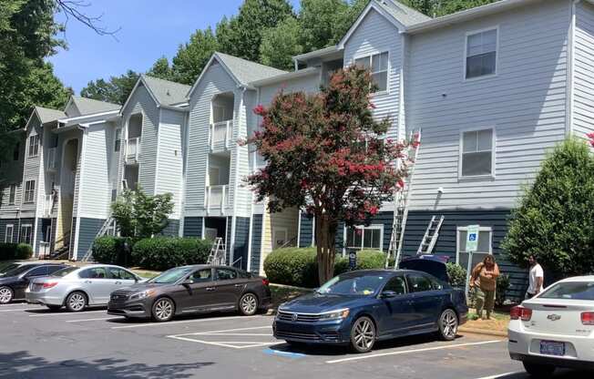 an apartment building with cars parked in front of it