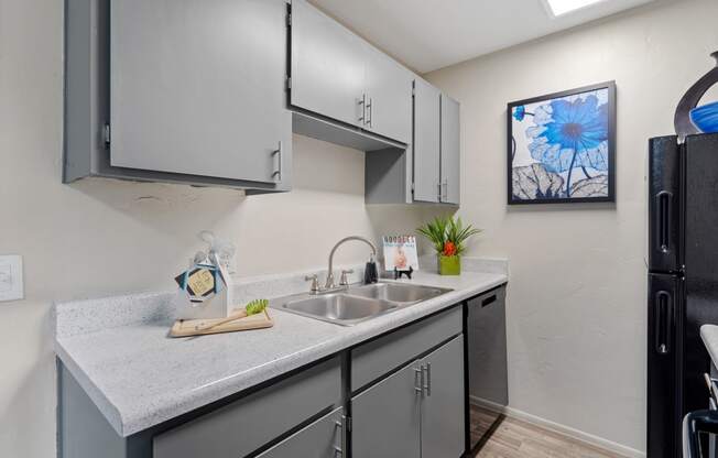 Redesigned kitchen is equipped with stainless steel appliances and a quartz counter top at Verde Apartments in Tucson, AZ, 85719