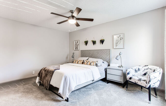 a bedroom with a large bed and a ceiling fan at Hidden Lake, Union City