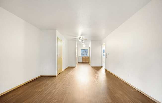 a living room with hardwood floors and white walls