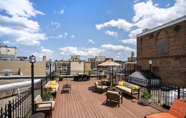 a roof deck with furniture and a view of the city