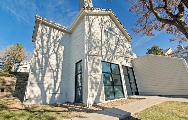 A white house with a black door and windows.