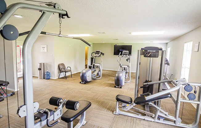 A well equipped gym with a variety of exercise equipment.