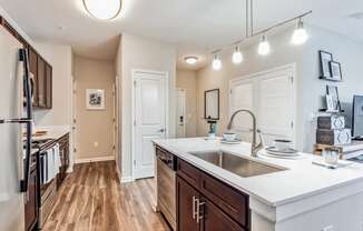 an open kitchen with a large counter top and a sink