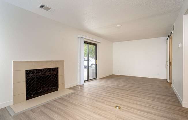 a bedroom with a fireplace and hardwood floors