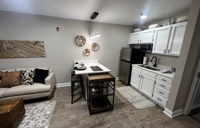 a kitchen and living room with a couch and a table