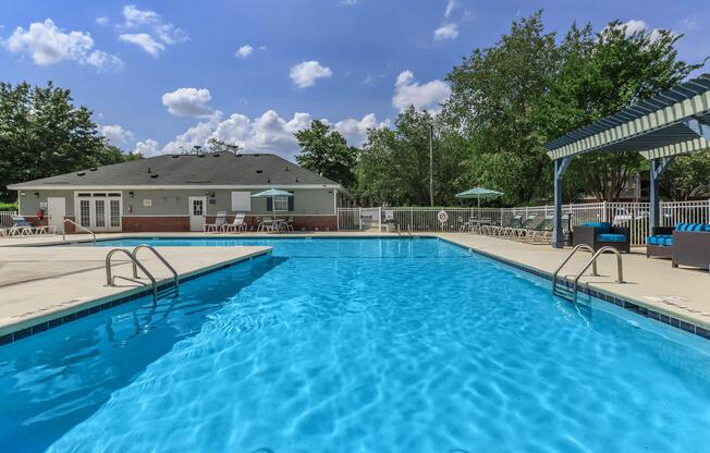 Swimming pool in front of a building at Ashley Oaks Apartments in Greensboro, North Carolina