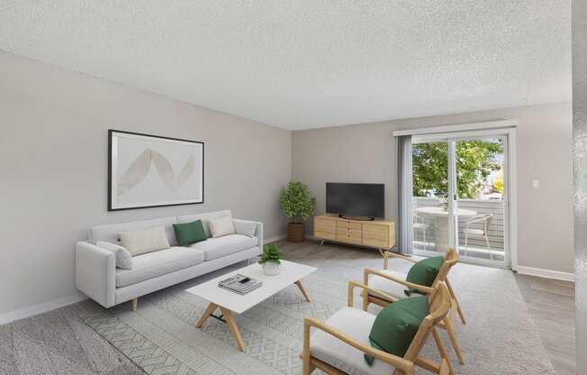 the living room of an apartment with a white couch and chairs