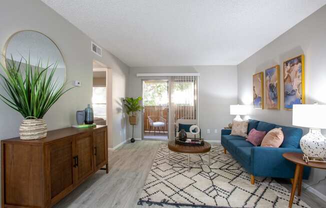 a living room with grey walls and a blue couch