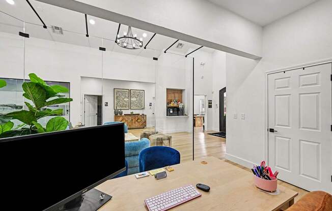 A modern home office with a desk, computer, and chair.
