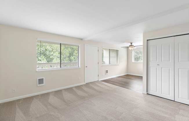 Living room with a closet and a window at Swiss Gables Apartment Homes, Kent, WA