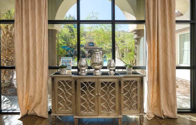 a sideboard with a view of the backyard
