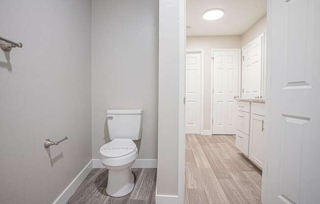 an empty bathroom with a toilet and a white closet