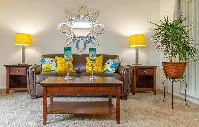 a living room filled with furniture and vase of flowers on a table