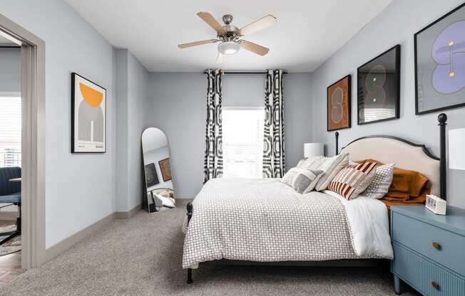 a bedroom with a bed and a ceiling fan