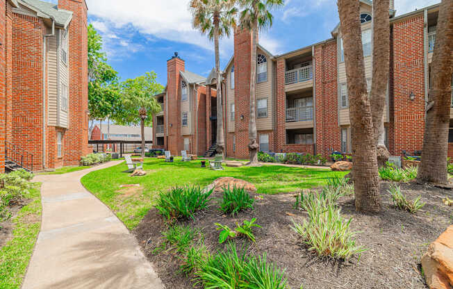 A brick building with a green lawn in front.