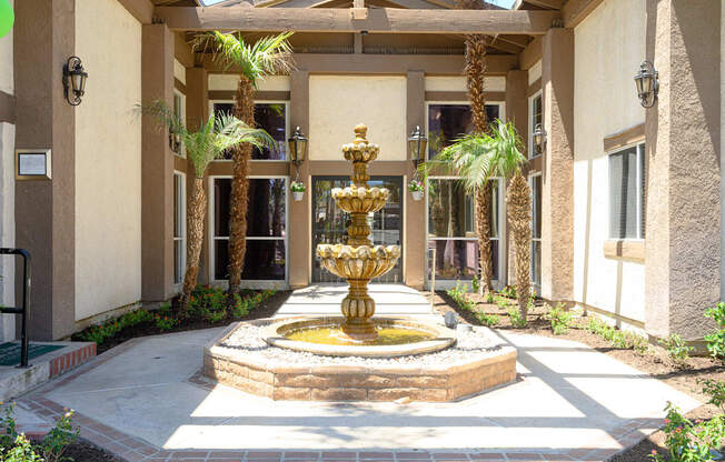 a fountain in front of a building at Oak Terrace Senior Apts, Hemet, 92543