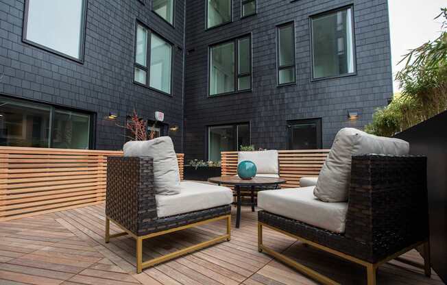 a patio with chairs and a table in front of a building at Analog Tacoma, Tacoma
