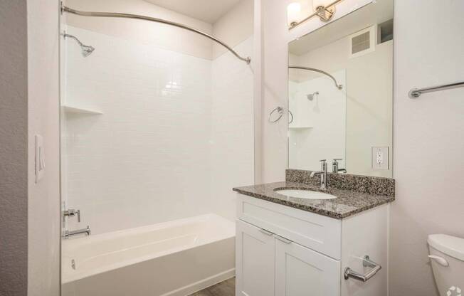 bathroom with white tub and sink with grey counter tops at Palisade Park Townhomes, Broomfield, Colorado, 80023
