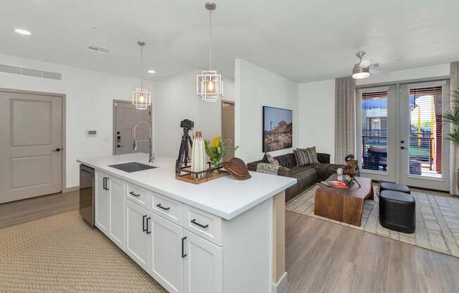 A modern kitchen with white cabinets and a large island.