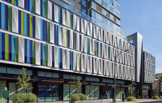 A modern building with a glass facade and a sign that says "Retail Space Available".