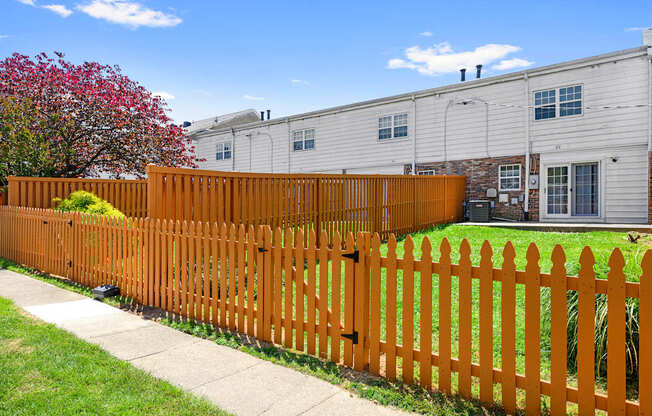 a wooden fence in front of a house