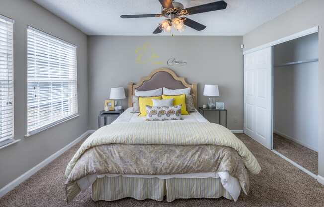 a bedroom with a large bed and a ceiling fan