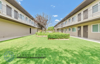 a large green lawn in the backyard of a building