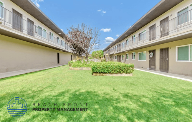 a large green lawn in the backyard of a building