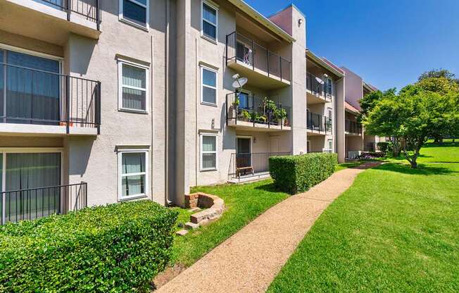 Apartment building with a green lawn in front.