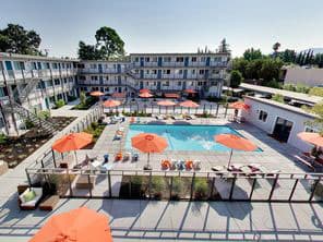 The Post Apartments pool area with umbrellas and lounge seating at THE POST Apartments, California, 94523