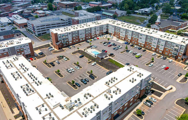 Overhead view of Park View Greer Apartments in Greer, SC, featuring a parking lot and a pool in the middle.